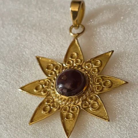 Gold Tone Brass Sun Star Pendant with Maroon Cabochon