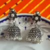 Add timeless elegance to your jewelry collection with these beautifully crafted **oxidized brass jhumka earrings**. Designed with a **floral stud top** and an intricately detailed **classic jhumka dome**, these earrings are finished with delicate **pearl bead danglers** that add graceful movement and charm. Inspired by traditional Indian craftsmanship, these earrings feature a vintage silver oxidized finish that pairs perfectly with sarees, lehengas, kurtis, and even Indo-western outfits. Lightweight yet statement-making, they are ideal for **festivals, weddings, parties, and everyday ethnic wear**. Perfect as a thoughtful gift for her—be it birthdays, anniversaries, weddings, or festive occasions.